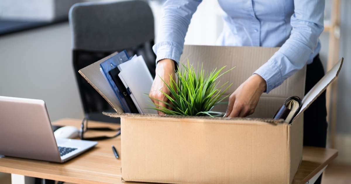 employee packing office desk supplies for her last day 